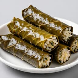 Flavorful Armenian Dolma, perfectly rolled grape leaves filled with seasoned rice and herbs. Classic Armenian dishes.