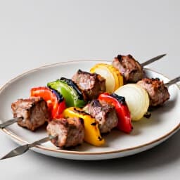 Succulent Armenian Khorovats skewers grilled to perfection with fresh vegetables. Traditional Armenian BBQ dishes.