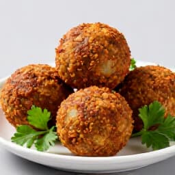 Authentic Falafel with Fresh Herbs. A beautifully arranged plate of crispy falafel, fresh salads, and a creamy dipping sauce, representing the vibrant flavors of Mediterranean cuisine.