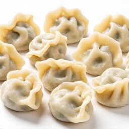 Chef meticulously preparing authentic Russian pelmeni dumplings by hand