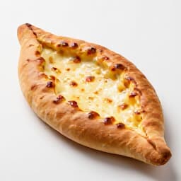 Traditional Armenian Khachapuri, a warm cheese-filled bread baked in a stone oven. A beloved specialty offered at Beluga Restaurant in San Francisco, showcasing rich flavors and authentic preparation.