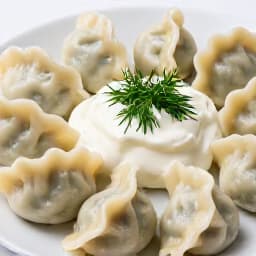 Freshly prepared homemade pelmeni, traditional Russian dumplings served with sour cream and dill, showcasing authentic Russian cuisine at Beluga Restaurant in San Francisco.