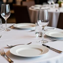 Elegant setting for corporate event catering in San Francisco. A beautifully arranged banquet hall with tables set for a corporate dinner or business event, highlighting sophisticated decor and professional service, ready to host your next successful gathering.