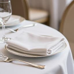 Elegant wedding rings on a table in a beautifully decorated event space at Beluga Restaurant & Banquet Hall in San Francisco, symbolizing exquisite celebrations.