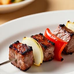 Exquisite Shish Kebab Catering for San Francisco Events. Deliciously grilled shish kebab skewers with vegetables, ready to be served at an elegant event setup, showcasing Beluga