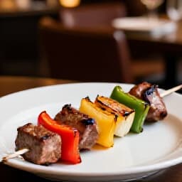 Perfectly grilled shish kebab served in an elegant restaurant setting, showcasing the authentic Armenian and Mediterranean cuisine available for dine-in at Beluga Restaurant in San Francisco.